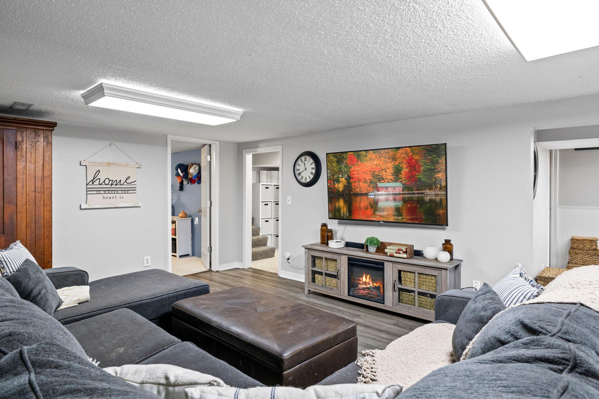 The expansive lower-level family room offers endless possibilities for relaxing and entertaining.