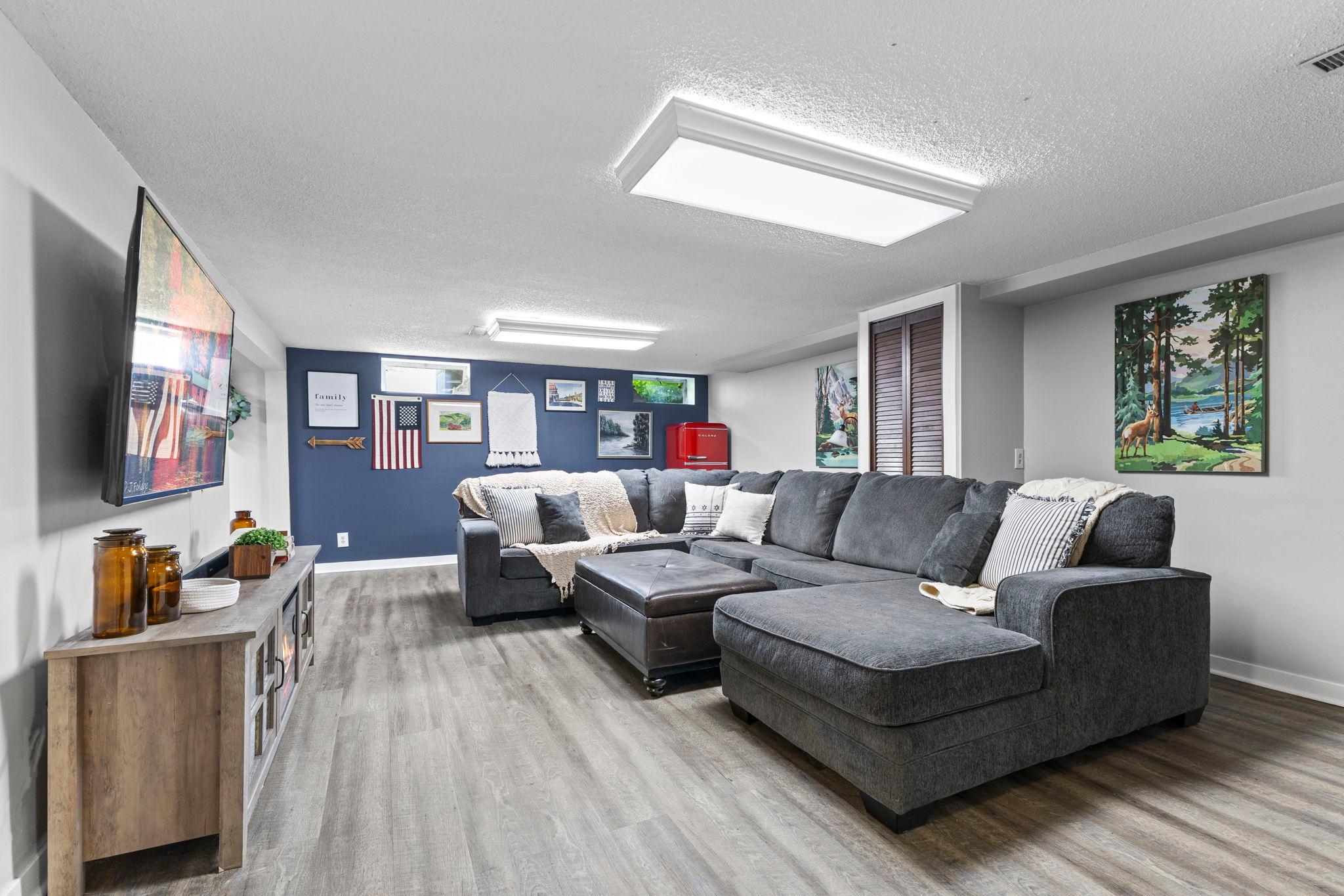 The finished lower level offers flexible space for movie nights, hobbies, or entertaining.