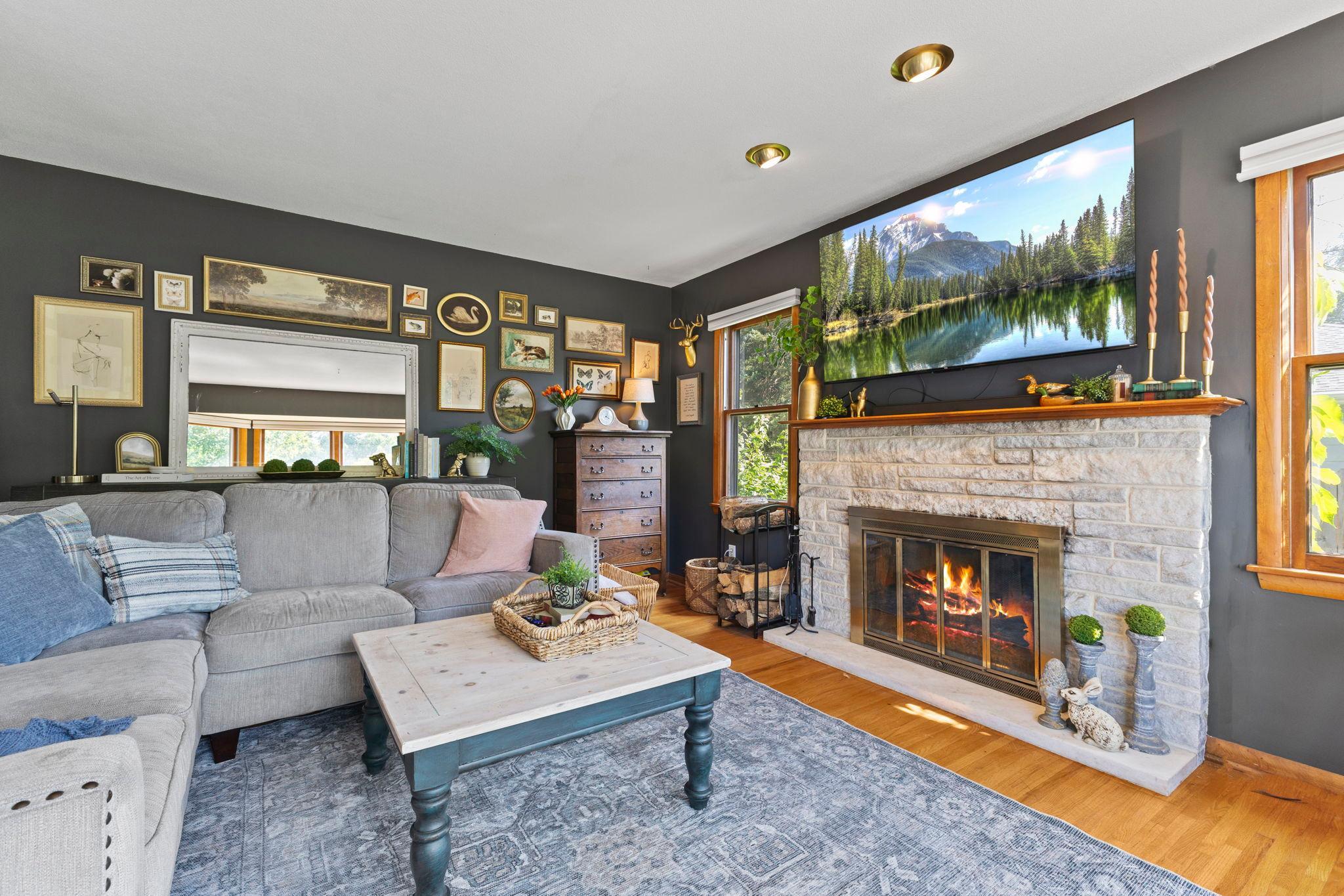 The beautiful stone fireplace serves as the focal point of the living room.