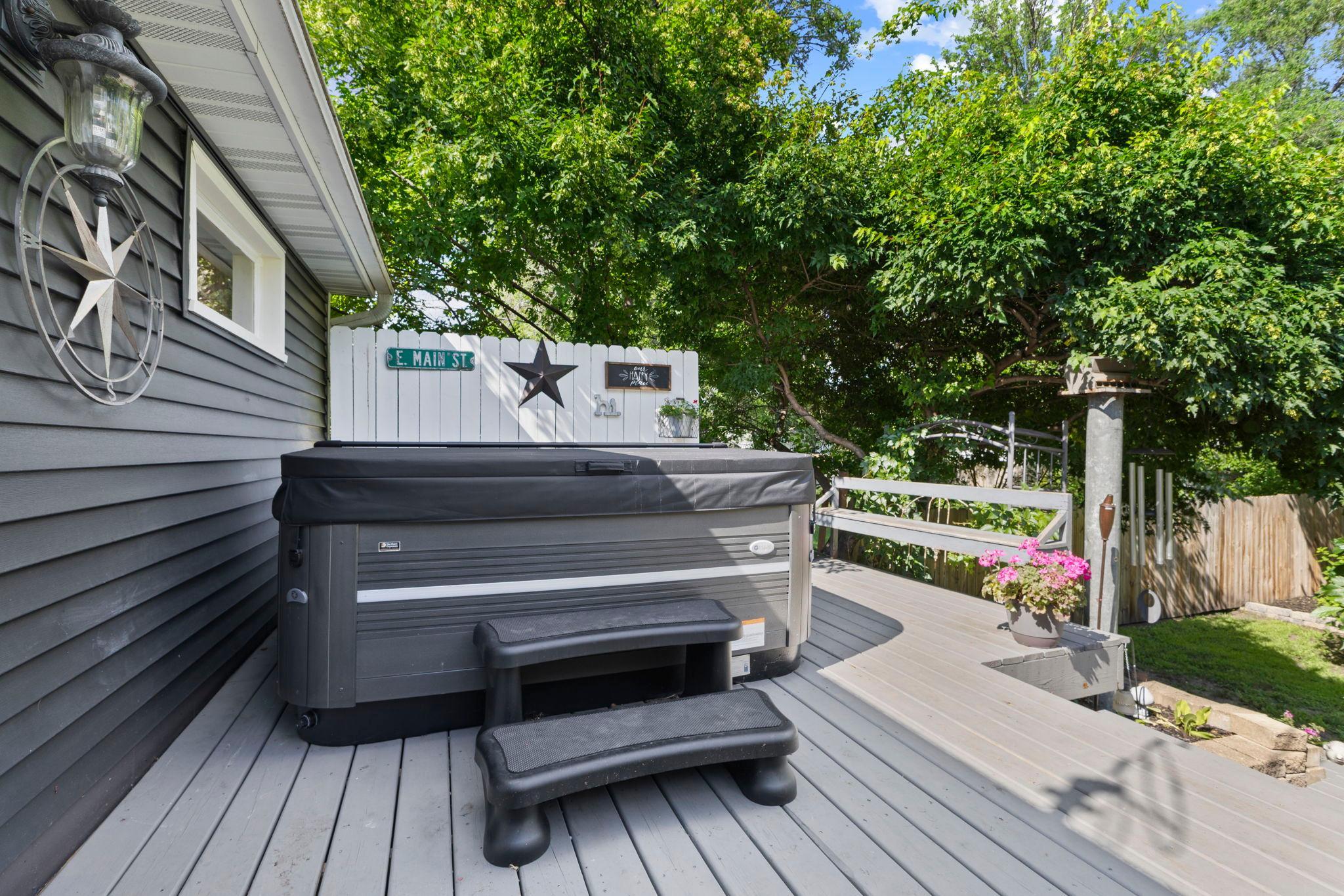 Unwind in the hot tub after a long day in your private backyard retreat.