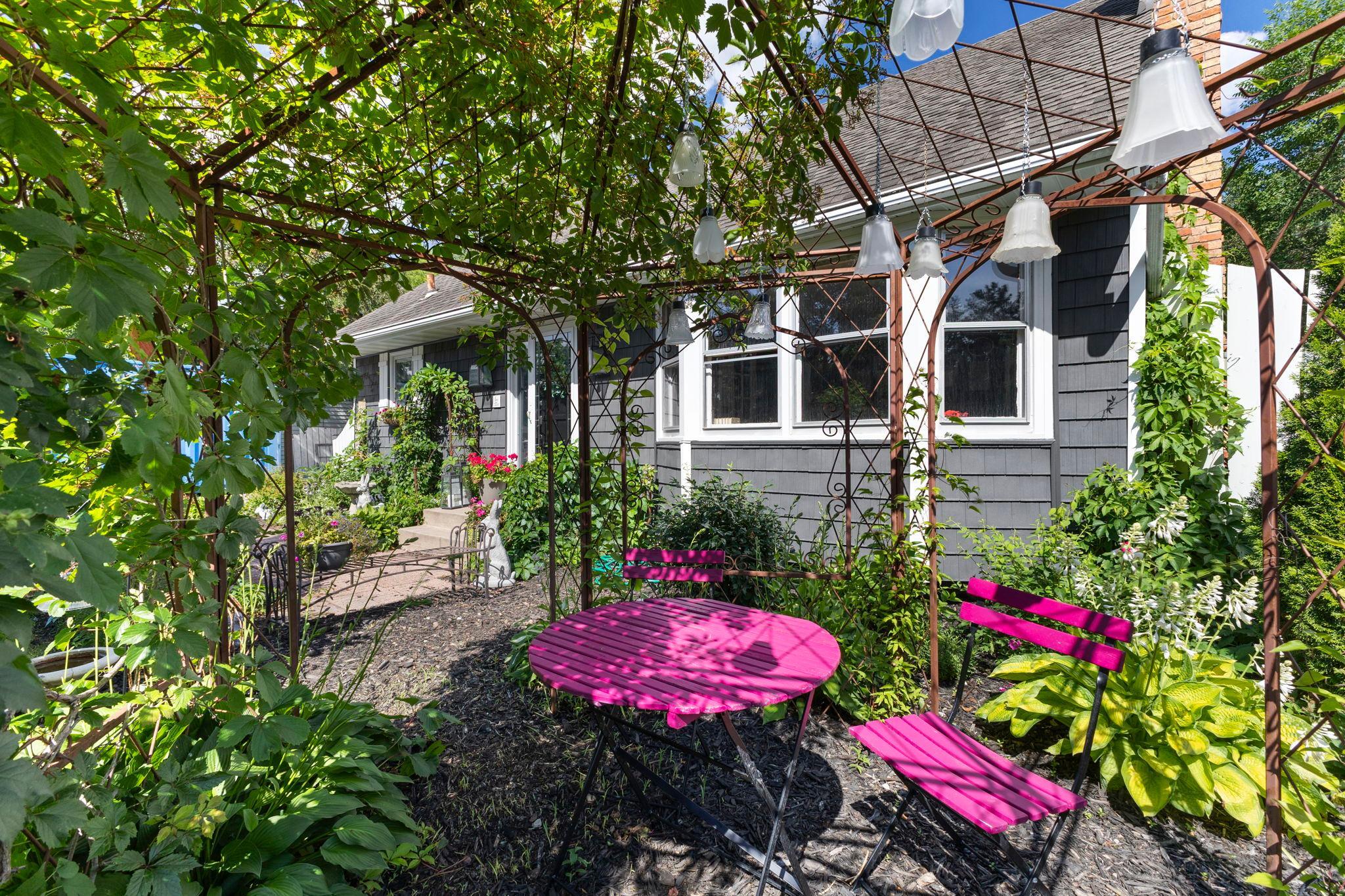 A charming garden path welcomes you into your own private backyard retreat.