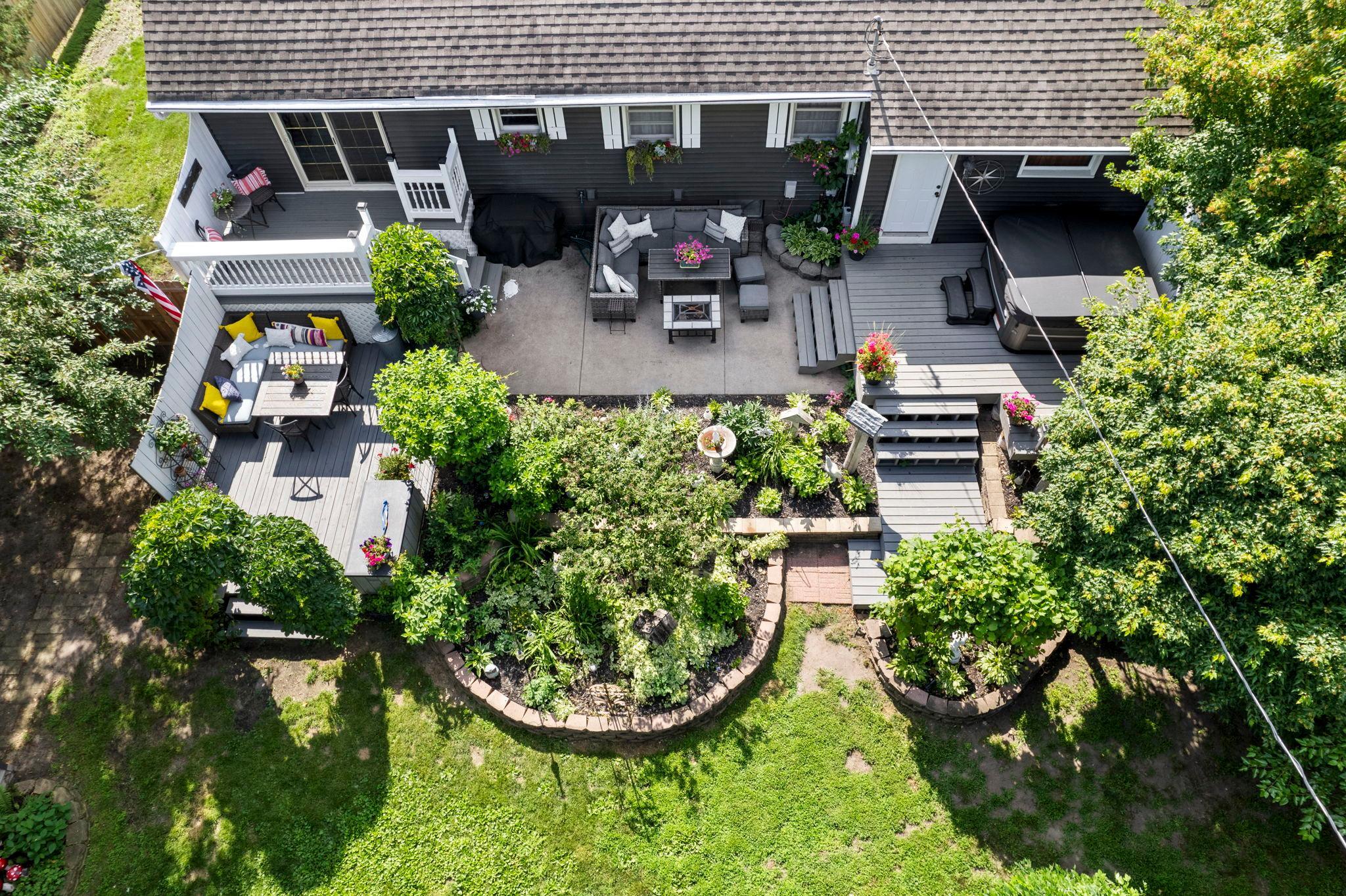 A bird's-eye view showcases the incredible outdoor living spaces and mature landscaping.