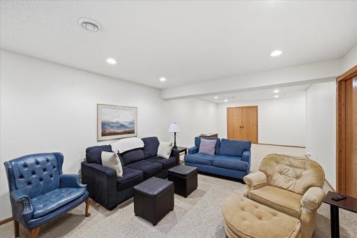 The finished lower level provides a spacious second living area with room for multiple seating arrangements, creating the perfect space for recreation, media, or family gatherings.