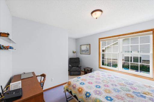 Bright and versatile main-level bedroom with a large window, generous natural light, and space for a desk or reading areaâperfect as a guest bedroom, home office, or hobby room.