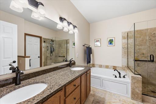 The spacious owner's ensuite features dual sinks, granite countertops, a relaxing soaking tub, and a separate walk-in showerâcreating a spa-like retreat for everyday comfort.