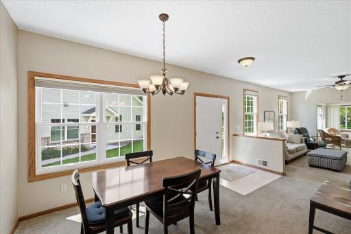 The spacious dining area is perfectly positioned adjacent to the kitchen, offering an inviting space for everyday meals, holiday gatherings, and effortless entertaining.