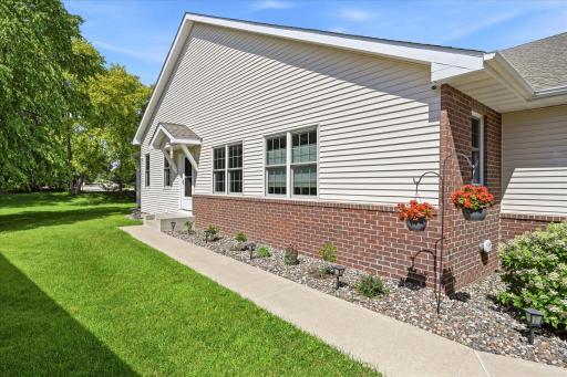 The end-unit location offers additional green space, mature landscaping, and enhanced privacy rarely found in townhome living.