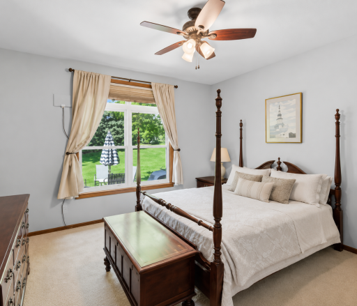 Enjoy the comfort of a spacious main-level owner's suite featuring large windows, abundant natural light, and relaxing views of the beautifully maintained green space.