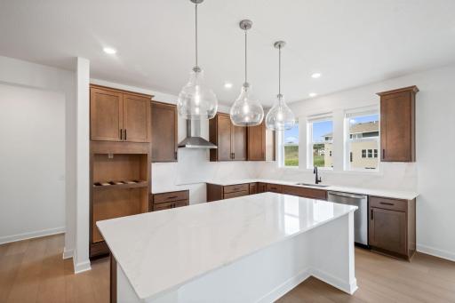 A modern kitchen creates a functional and stylish space to create chef-inspired meals with sleek cabinetry and brand-new stainless steel appliances.