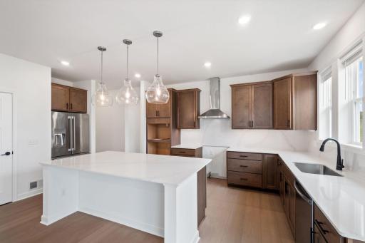 The generous center island is ready for meal prep or casual meals at the breakfast bar