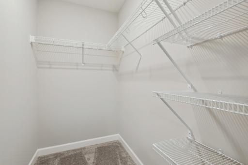 (Photo of a decorated model, actual homes finishes will vary) The primary bedroom features an incredible walk-in closet.
