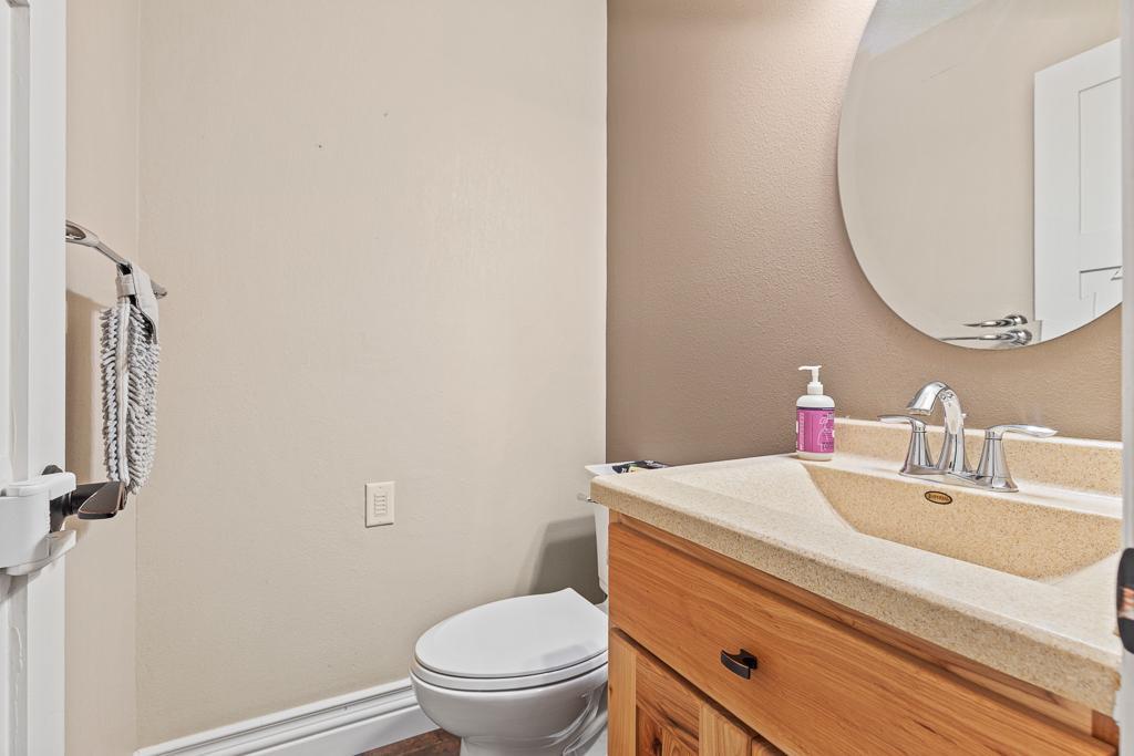 Main floor half bath just inside the attached garage entry