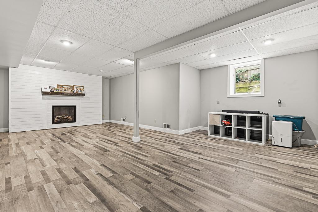 Spacious lower level family room with cozy fireplace