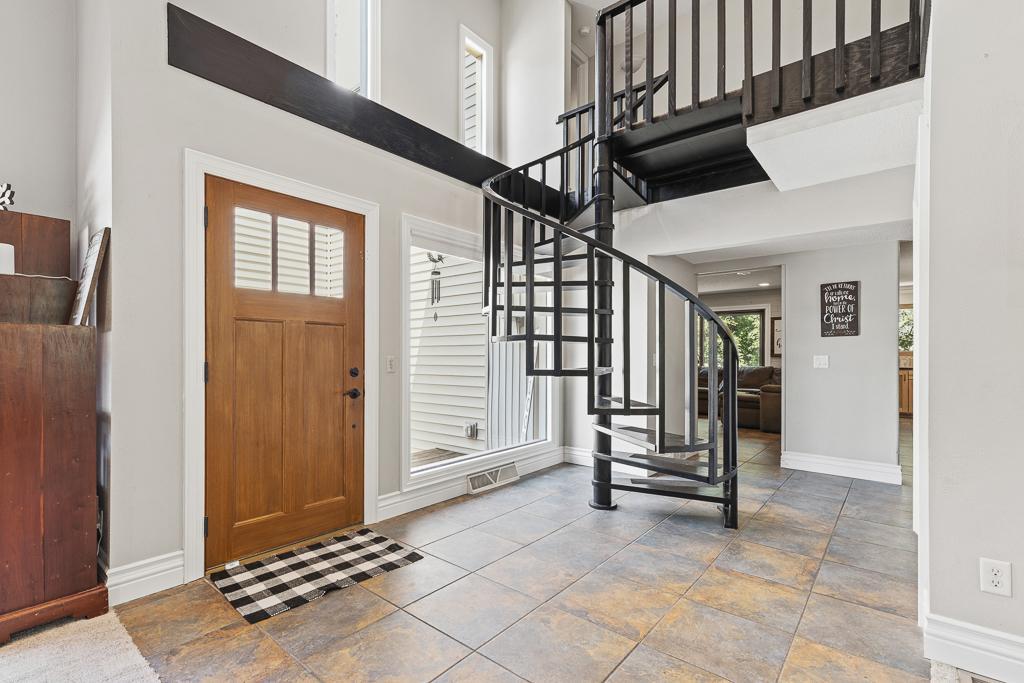 Can't get over this spiral staircase and large front window as you step inside.