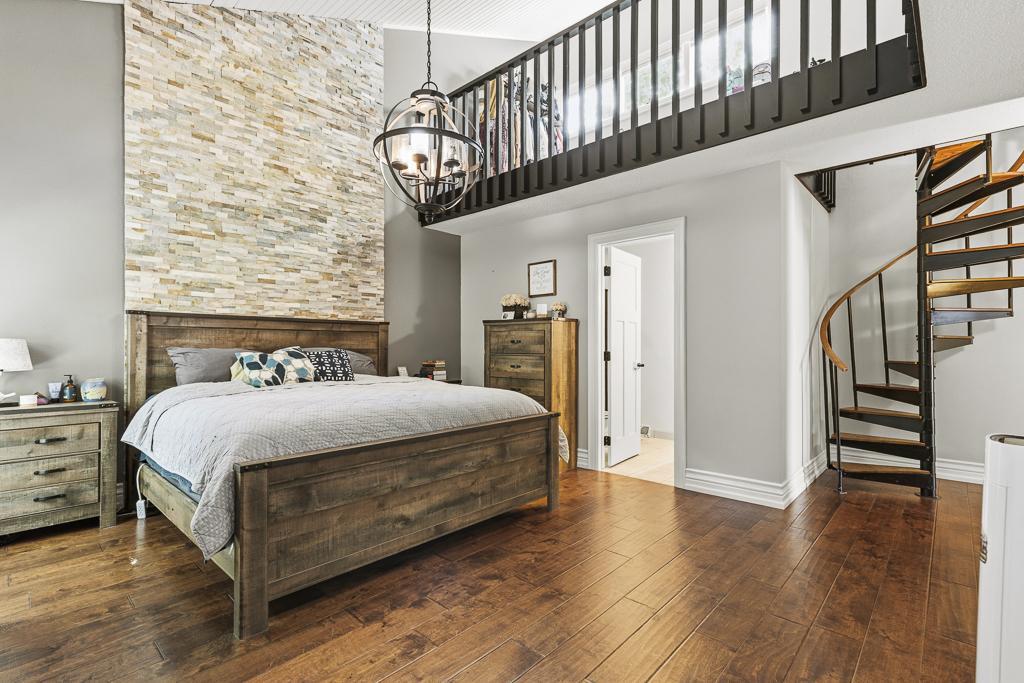Absolutely adore this primary bedroom suite! You'll also find a spiral staircase and finished loft above!