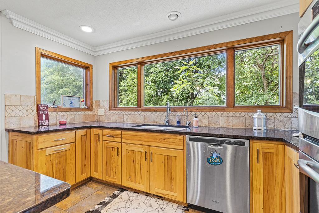 Plenty of natural light for the kitchen as windows surround much of the space and offer natural views of the surrounding trees