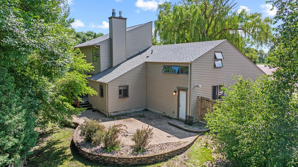 The rear side of the home features a spacious patio ready for summer evening entertainment
