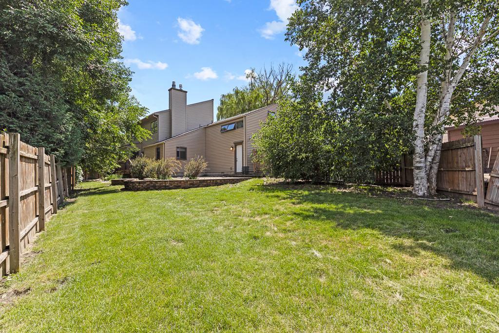 Private backyard with wood fencing surrounding the yard