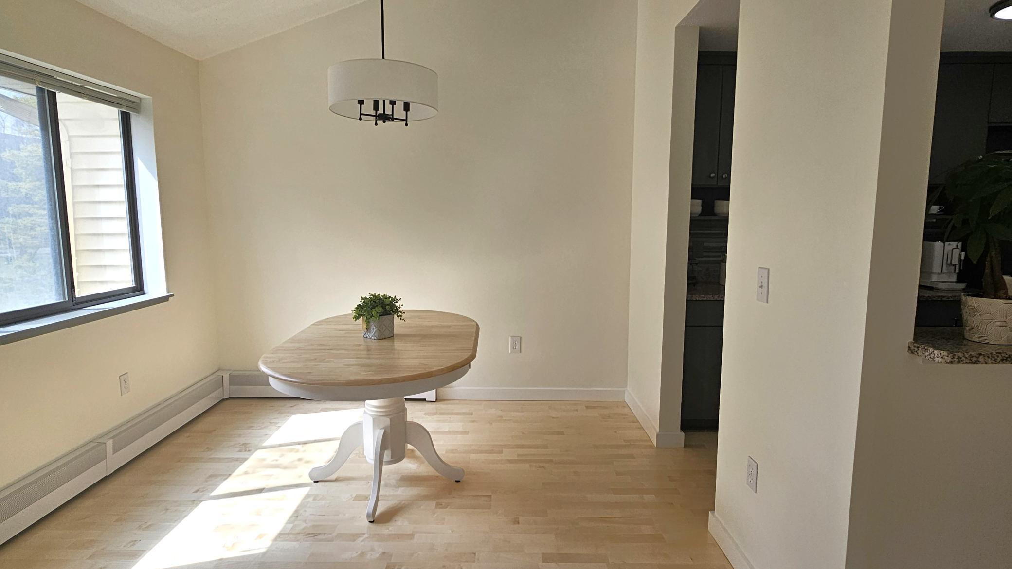 The bright and sunny dining room features vaulted ceilings.jpg