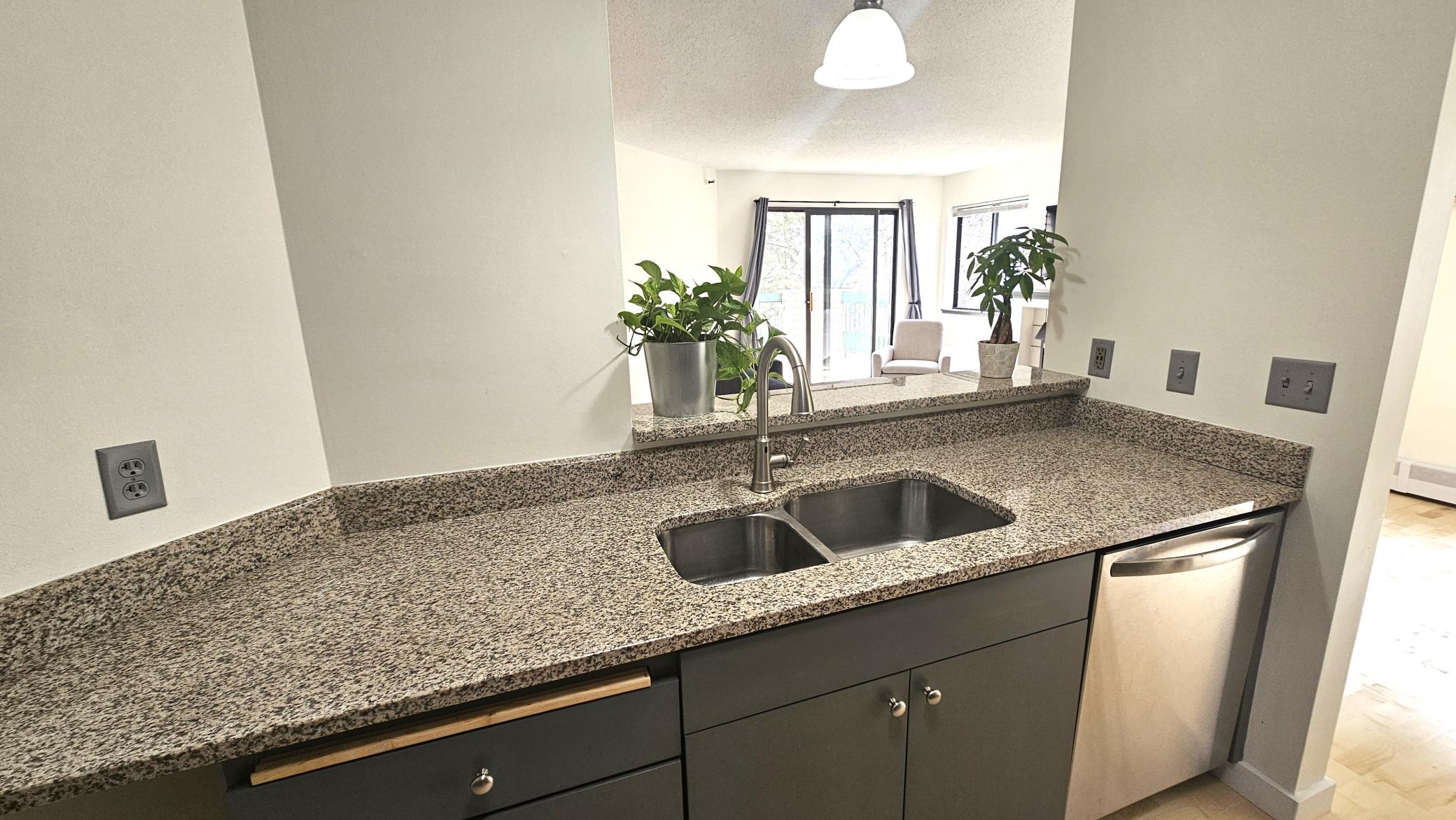 The kitchen includes granite countertops and breakfast bar.jpg