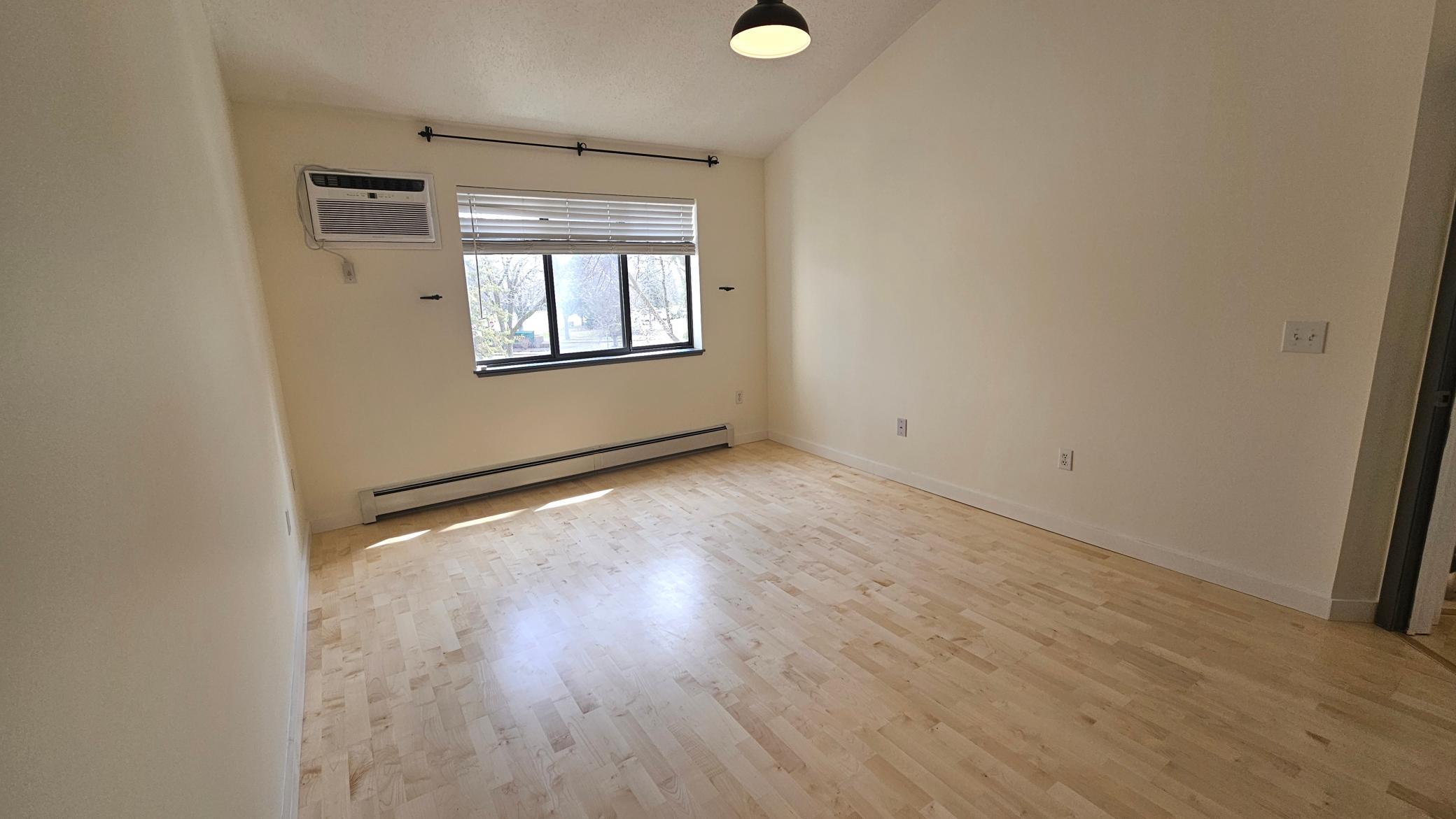 Luxurious main bedroom with vaulted ceilings, walk in closet & direct bathroom access.jpg