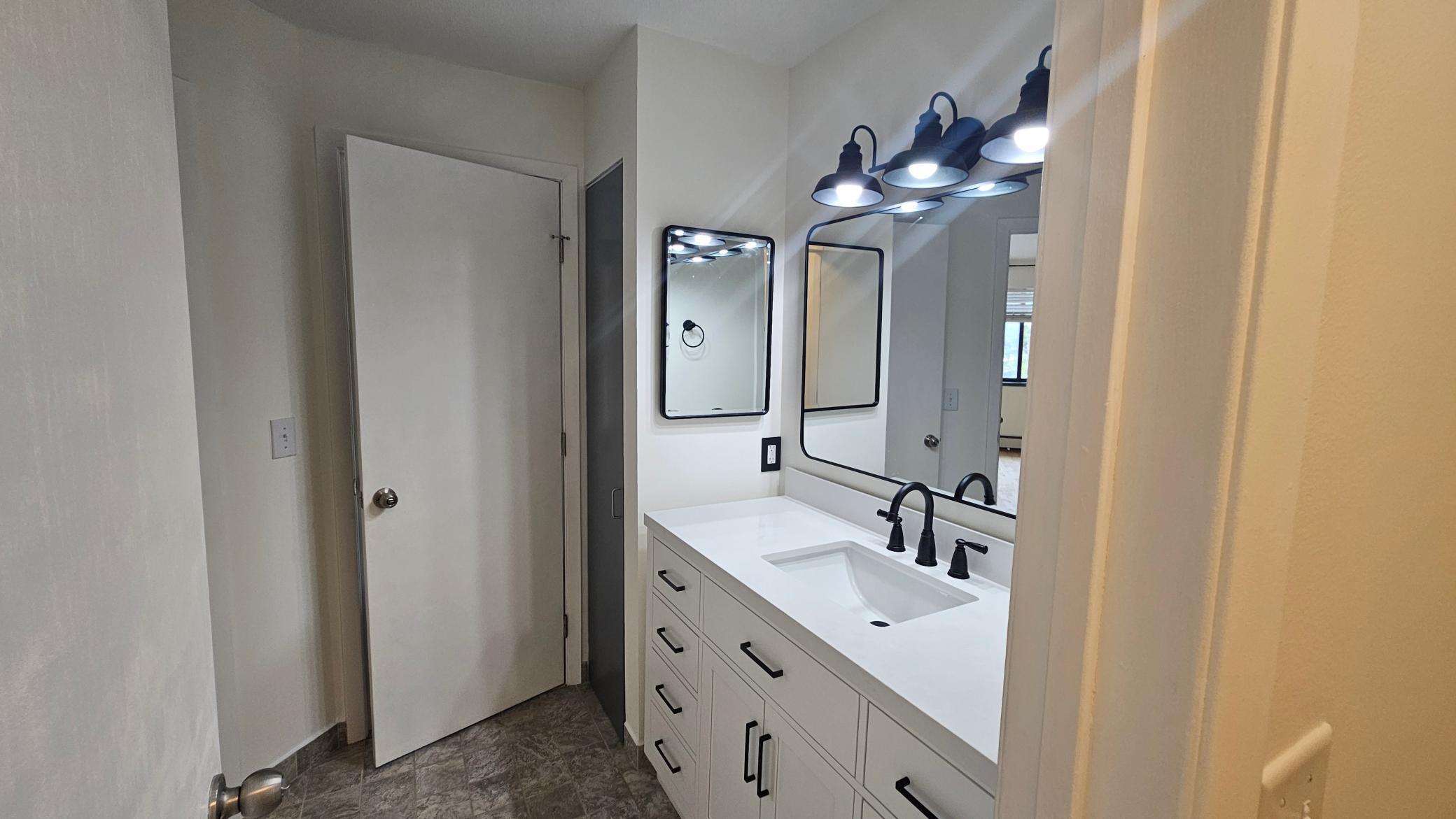 Designer bath vanity and mirrors with linen closet.jpg