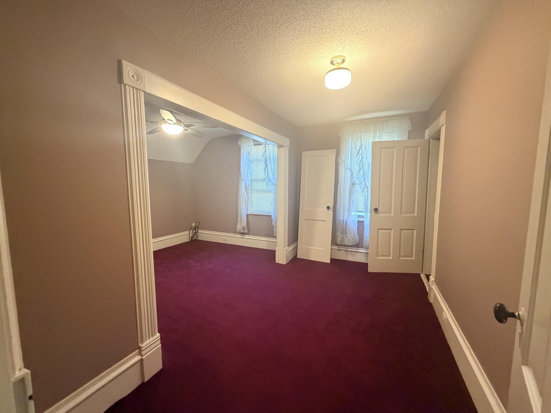 Huge primary bedroom with ceiling fan and double closets