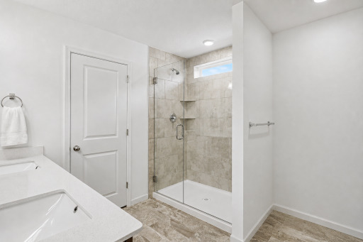 Primary Bath with duel walk in closets - AI used to remove personal items only