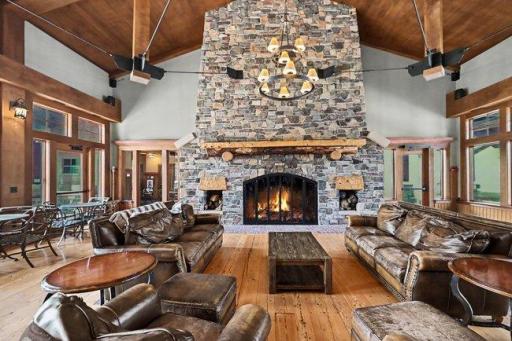 Clubhouse Great Room Elegant clubhouse gathering room featuring soaring vaulted ceilings and a stunning floor-to-ceiling stone fireplace.