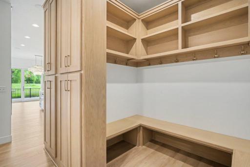 Custom back entry mudroom with built-in cabinetry, bench seating, and abundant storage for everyday organization.