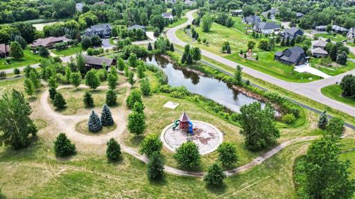Expansive neighborhood greenspace featuring picturesque ponds, winding walking paths, and family-friendly parks throughout The Territory.