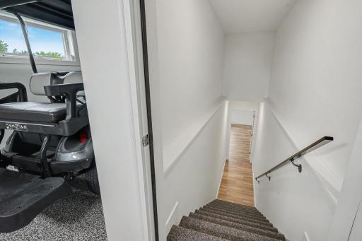 Private staircase provides direct access from the lower level to the oversized heated garage, adding convenience and functionality.