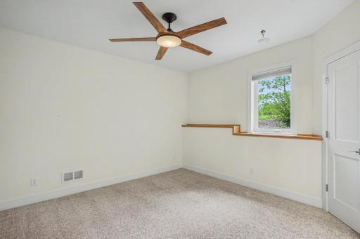 Lower level bedroom has look-out window, letting in a lot of light.