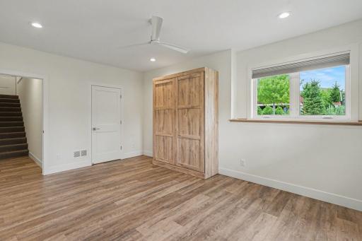 This lower level room with a look out window also has a door that opens to stairs leading up to garage.