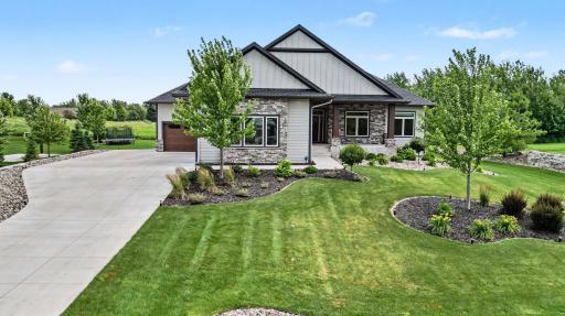 Beautifully landscaped front yard welcomes you with lush gardens, mature landscaping, and outstanding curb appeal.
