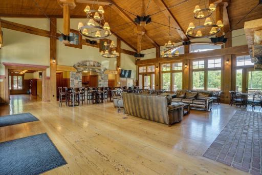 The Territory clubhouse features an expansive gathering space with soaring timber ceilings, abundant natural light, and comfortable seating for relaxing or socializing.