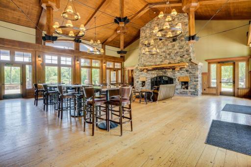 Beautifully appointed clubhouse entertainment space featuring a full gathering area with bar seating, ideal for hosting parties, celebrations, and community events.
