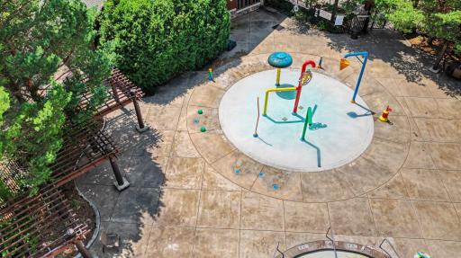 Colorful interactive splash pad offers a safe and exciting place for children to cool off and enjoy endless summer fun.