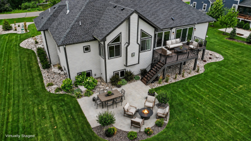 Exceptional outdoor living featuring a large maintenance-free deck and beautifully designed patio with a fire pitâperfect for relaxing or entertaining while enjoying picturesque views.(Virtually staged photo)
