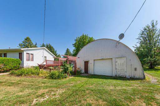 Quanset next to home with garage door opener