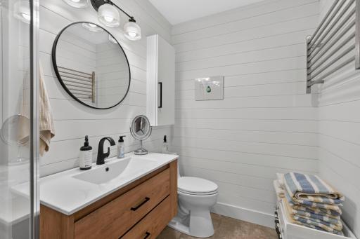 Updated primary 3/4 bath w/ towel warming rack