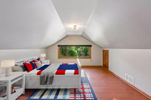 The upper level offers a generous primary bedroom with a half bathroom (virtually staged).