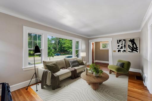 Sun-filled living spaces are enhanced by large windows that fill the home with natural light (virtually staged).
