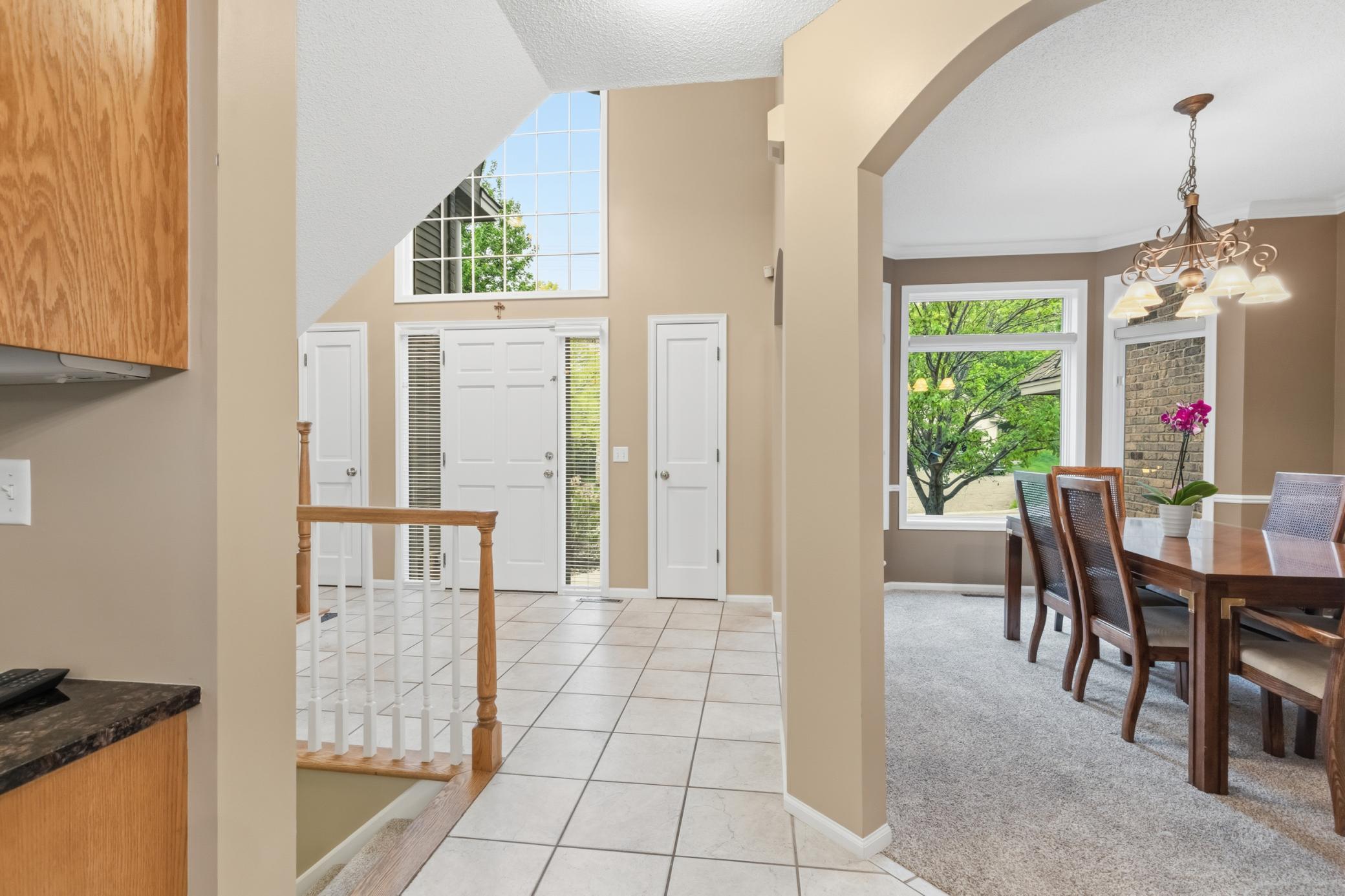 Another view of the foyer showing the large window above the door. Two closets on both sides of the door.