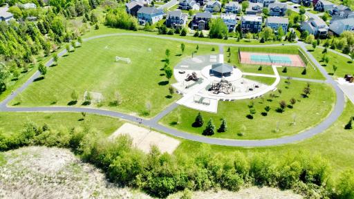 Neighborhood park featuring playground, trails, and open green space just moments from the home