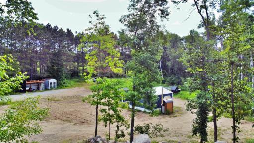 Aerial view over lot with chicken coop and wood shed.jpg
