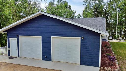 Garage with double doors and serivce door walkway to home.jpg