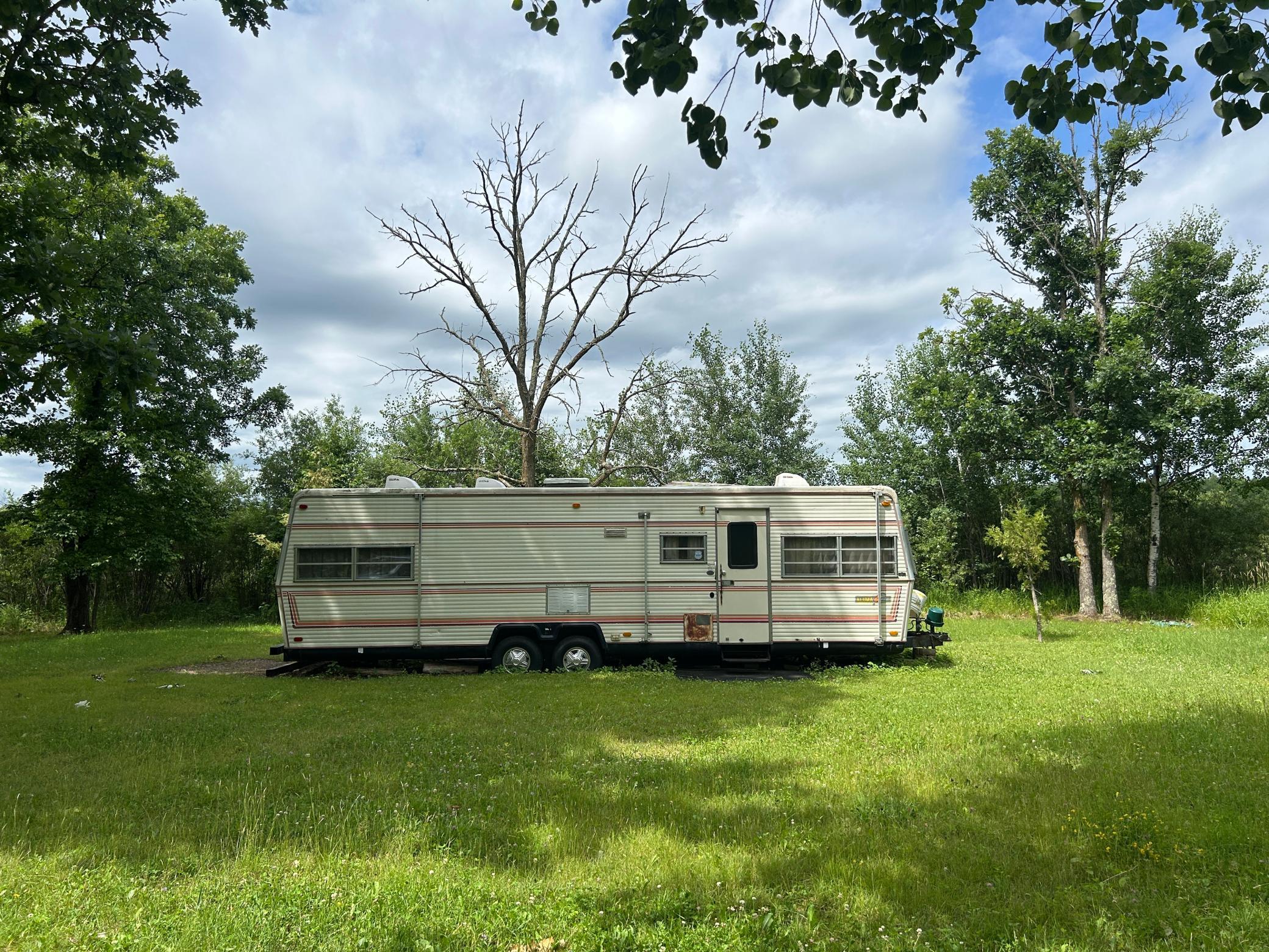 1982 Aluma-lite travel trailer included with sale.