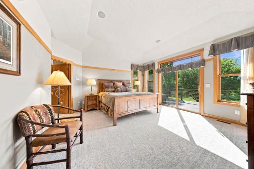 The private owner's retreat offers direct access to the deck, spectacular river views, a spacious walk-in closet, and a spa-inspired bath featuring heated floors, dual vanities, a soaking tub, and an oversized walk-in shower with dual shower heads.