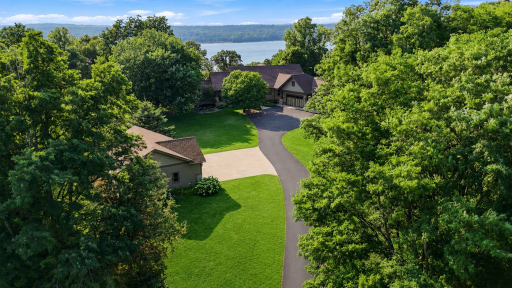 Perched atop the scenic bluffs of the St. Croix River, this extraordinary Bruce Lenzen-designed custom estate, beautifully curated by Cocobello Interiors, blends breathtaking river views. Located just one mile from Troy Burne Golf Club.